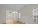 Bright dining room with wood floors, wainscoting, and a view into an adjacent living space at 2018 Rockycreek Ln, Monroe, NC 28112