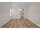 Open dining room with wood floors, wainscoting, and a stylish chandelier at 2018 Rockycreek Ln, Monroe, NC 28112