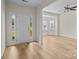 Bright entryway with a front door with glass panels and luxury vinyl flooring at 2018 Rockycreek Ln, Monroe, NC 28112