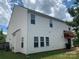 The rear of the home features vinyl siding, many windows, and a small awning at 2018 Rockycreek Ln, Monroe, NC 28112