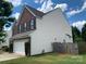 Two-story home featuring a two-car garage, brick, and vinyl siding at 2018 Rockycreek Ln, Monroe, NC 28112