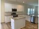 Beautiful kitchen with white cabinets, stainless steel appliances, island, and granite countertops at 2018 Rockycreek Ln, Monroe, NC 28112