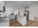 Modern kitchen featuring white cabinets, granite countertops, stainless steel appliances, and an island at 2018 Rockycreek Ln, Monroe, NC 28112