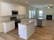Modern kitchen with white cabinetry, stainless steel appliances, granite countertops, and center island at 2018 Rockycreek Ln, Monroe, NC 28112