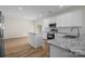 Bright, updated kitchen featuring white cabinets, stainless steel appliances, and granite countertops at 2018 Rockycreek Ln, Monroe, NC 28112