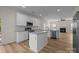 Modern kitchen featuring white cabinets, stainless steel appliances, an island, and hardwood floors at 2018 Rockycreek Ln, Monroe, NC 28112