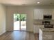 Eat-in kitchen with white cabinets, stainless steel appliances, granite counters, and sliding door to backyard at 2018 Rockycreek Ln, Monroe, NC 28112