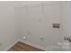 Laundry room featuring washer/dryer hookups, electrical outlets and modern flooring at 2018 Rockycreek Ln, Monroe, NC 28112