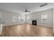 Open living room is complete with modern flooring, a ceiling fan, and a fireplace at 2018 Rockycreek Ln, Monroe, NC 28112