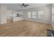 Open living space with ceiling fan, fireplace, modern kitchen and lots of natural light at 2018 Rockycreek Ln, Monroe, NC 28112