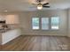 Bright living space with white cabinets, granite countertops, and view into a window-filled living area at 2018 Rockycreek Ln, Monroe, NC 28112