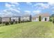 Backyard view of several houses with landscaped lawns and fences at 214 Blossom Ridge Dr, Mooresville, NC 28117