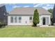 View of the back of a house with a lawn, and a patio at 214 Blossom Ridge Dr, Mooresville, NC 28117