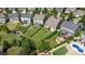 Aerial view of backyards featuring patios, seating areas, lush landscaping, and outdoor living spaces at 214 Blossom Ridge Dr, Mooresville, NC 28117