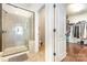 Bathroom featuring a glass-enclosed shower and adjacent walk-in closet at 214 Blossom Ridge Dr, Mooresville, NC 28117