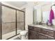 Bathroom with a granite countertop vanity and a walk-in tiled shower at 214 Blossom Ridge Dr, Mooresville, NC 28117