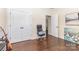 A bedroom with dark wood floors, a closet, and an adjacent doorway at 214 Blossom Ridge Dr, Mooresville, NC 28117