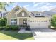 Charming single-Gathering home featuring a manicured lawn and an attached two-car garage at 214 Blossom Ridge Dr, Mooresville, NC 28117
