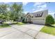 Charming single-Gathering home on a tree-lined street with a well-manicured lawn and two-car garage at 214 Blossom Ridge Dr, Mooresville, NC 28117