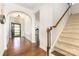 Inviting foyer with hardwood floors, staircase, and arched entryway leading to other rooms at 214 Blossom Ridge Dr, Mooresville, NC 28117