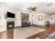 Bright living room featuring a fireplace and hardwood flooring, with comfortable seating at 214 Blossom Ridge Dr, Mooresville, NC 28117