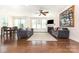 Bright and airy living room featuring hardwood floors, a fireplace, and ample natural light at 214 Blossom Ridge Dr, Mooresville, NC 28117