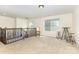 Open loft space with neutral carpet and a wooden railing and stairs at 214 Blossom Ridge Dr, Mooresville, NC 28117