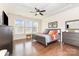 Bright main bedroom with hardwood floors, tray ceiling, and large windows at 214 Blossom Ridge Dr, Mooresville, NC 28117