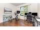 Bright office space with a window, dark hardwood floors, and an exercise bike setup at 214 Blossom Ridge Dr, Mooresville, NC 28117