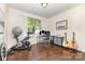 Bright office space with hardwood floors, a large window, and exercise equipment at 214 Blossom Ridge Dr, Mooresville, NC 28117
