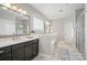 Well-lit bathroom featuring a double sink vanity, a soaking tub and a glass enclosed shower at 220 Forsythia Ln, Tega Cay, SC 29708