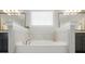 Close up view of a tub with a faucet between two dark wood vanities, with two mirrors at 220 Forsythia Ln, Tega Cay, SC 29708