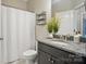 Modern bathroom featuring a sink vanity, granite countertop, and a shower-tub with a curtain at 220 Forsythia Ln, Tega Cay, SC 29708