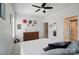 Neutral colored bedroom with ceiling fan, wooden dresser, with view of the bathroom at 220 Forsythia Ln, Tega Cay, SC 29708