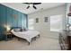 Bedroom with a unique, blue accent wall, ceiling fan, and two windows at 220 Forsythia Ln, Tega Cay, SC 29708