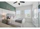 Bright bedroom with a ceiling fan, two windows and a bed with baseball-themed decorative pillows at 220 Forsythia Ln, Tega Cay, SC 29708