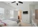 Bright bedroom featuring a ceiling fan, plush carpet, and an adjoining bathroom at 220 Forsythia Ln, Tega Cay, SC 29708