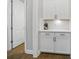 Charming butler's pantry with white cabinets, subway tile backsplash, and quartz countertops at 220 Forsythia Ln, Tega Cay, SC 29708