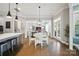 Bright dining area featuring a white table set and views into the living room and kitchen at 220 Forsythia Ln, Tega Cay, SC 29708