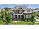 Beautiful two-story home with brick and siding, lush landscaping, and inviting front porch at 220 Forsythia Ln, Tega Cay, SC 29708