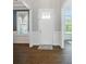 Bright foyer features a white front door, elegant trim, and rich hardwood flooring at 220 Forsythia Ln, Tega Cay, SC 29708