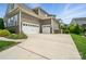 Spacious three-car garage with ample driveway space for parking and storage at 220 Forsythia Ln, Tega Cay, SC 29708