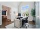 Light-filled home office with a view, featuring custom desk, and wainscoting at 220 Forsythia Ln, Tega Cay, SC 29708