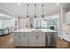 Open kitchen with large island, stainless steel appliances, and views of the living area at 220 Forsythia Ln, Tega Cay, SC 29708