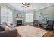 Inviting living room boasts a fireplace, comfortable seating, natural light, and decor shelves at 220 Forsythia Ln, Tega Cay, SC 29708