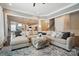 Open-concept living room with plush seating, tray ceiling, and view to staircase at 220 Forsythia Ln, Tega Cay, SC 29708