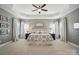 Spacious main bedroom featuring gray walls, and a decorative tray ceiling with a ceiling fan at 220 Forsythia Ln, Tega Cay, SC 29708