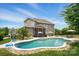 A spacious backyard featuring a large in-ground pool, surrounded by mature landscaping at 220 Forsythia Ln, Tega Cay, SC 29708