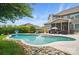 A lovely in-ground pool, surrounded by landscaping and a spacious patio at 220 Forsythia Ln, Tega Cay, SC 29708