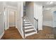 Bright foyer with a wooden staircase, leading to a naturally lit upper level hallway at 220 Forsythia Ln, Tega Cay, SC 29708